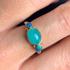 We adore the simultaneous simplicity and depth in this Amazonite cab. A spectacular ocean blue with 14k gold beads opal doublets and a handmade sterling silver seagrass band this ring is a perfect piece to add to any collection. Approx stone size: 10mm x 7mm CT weight: 2.5ct This one of a kind mixed metal piece is handmade in our Hudson Valley NY studio and currently a size 7.5 but can be resized prior to shipping. If you would like more photos videos or have questions about shipping, sizing or Blue Opal Cabochon Ring, Amazonite Ring, Peruvian Opal, Local Jewelry, Cabochon Ring, Australian Opal, Mixed Metals, Hudson Valley, Ocean Blue