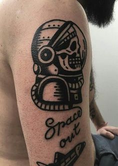 a man with a skull tattoo on his arm