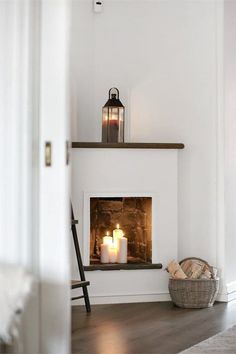 a fireplace with two lit candles in it