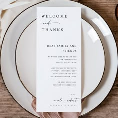 a table setting with plates and place cards on it, including an empty menu card