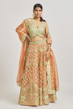 Deep peach attached cancan lehenga with gota applique, sequin, thread embroidery in floral pattern. Paired with halter neck embroidered padded blouse and dupatta.
Components: 3
Pattern: Embroidery
Type Of Work: Gota applique, sequin, thread
Neckline: Halter neck
Sleeve Type: Sleeveless
Fabric: Organza
Color: Peach
Other Details: 
Lehenga:
Attached cancan
Floral pattern
Approx Product Weight: 4-5 kgs
Blouse:
Padded
Crystal drops on hem
Rounded hem
Side tassel detailing
Dupatta:
Scallop embroidere Peach Saree Set With Zari Work, Peach Dupatta With Zari Work For Reception, Peach Zari Work Sets, Reception Peach Dupatta With Zari Work, Bollywood Peach Traditional Drape Sets, Peach Traditional Wear With Dupatta For Reception, Semi-stitched Peach Choli With Sheer Dupatta, Peach Semi-stitched Choli With Sheer Dupatta, Festive Peach Zari Work Sets