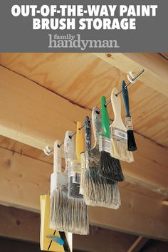 brush holders are hanging from the ceiling with text overlay that reads out - of - the - way paint brush storage