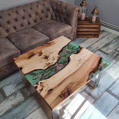 a couch and table in a room with wood flooring next to a brown couch