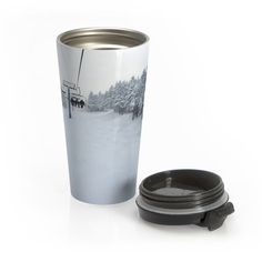 a stainless steel travel mug with an insulated lid and the image of a ski lift