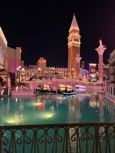 the las vegas strip at night with gondolas and buildings