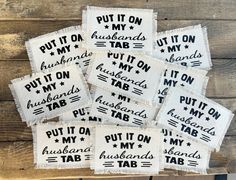 six white and black embroidered coasters with words on them, put it on my husband