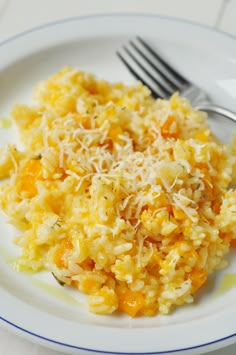 a white plate topped with rice covered in cheese