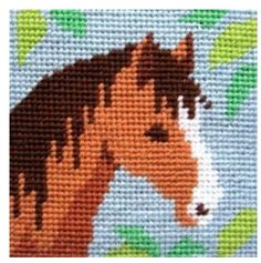 a cross stitch pattern of a horse with leaves on it's head and brown mane