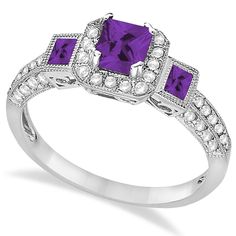 an engagement ring with purple stones and diamonds on the sides, set in 18k white gold