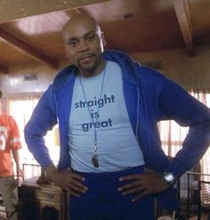 a man standing in front of a mirror wearing a blue shirt with the words straight is great on it