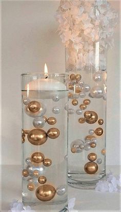 two clear vases filled with gold and white ornaments