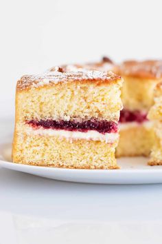 a piece of cake on a white plate with the rest of it cut in half