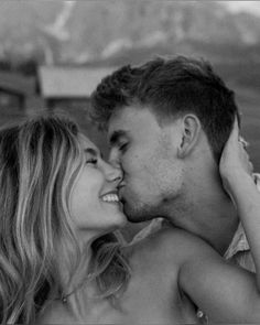 black and white photograph of a man kissing a woman's forehead with her eyes closed