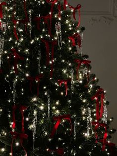 a christmas tree with red bows and lights