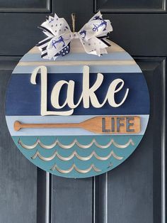 a lake life sign hanging on the front door