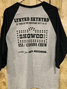 "Lynyrd Skynyrd 1977 tour jersey celebrating the \"Tour of the Survivors\" (TOTS). Shirts like these were originally designed for the Showco sound engineers traveling on that tour. This tour began on 10/15/1977 and was scheduled to run into 1978. Tour ended when the band's plane crashed enroute to a concert. This shirt is not 44 years old. Size XL-gray jersey with black sleeves and black printing on both sides. NWOT" Black Sleeves, Lynyrd Skynyrd, Sound Engineer, Graphic Tees, Sound, Adult Outfits, Tops & Tees, Top Outfits, Concert