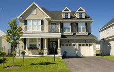 a two story house with white trim and black shutters