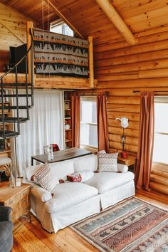 a living room filled with furniture and a spiral staircase