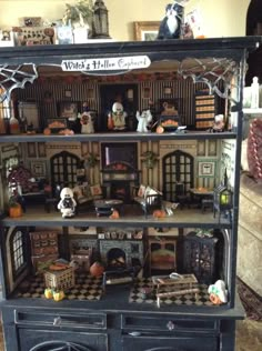 a doll house with lots of furniture and decorations on it's display shelf in the living room