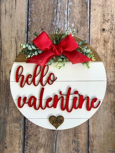 a wooden sign that says hello valentine with a bow on the front and back of it