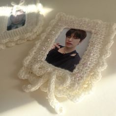 a white crocheted photo frame with a woman's face in it