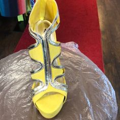 4 Inch Yellow Stiletto Cutout Heel With Gold Design And A Zipper On Back. Heel Is Foil Gold Trendy Yellow Heels For Party, Yellow Round Toe Heels For Party, Yellow Open Toe Heels For Party, Yellow Synthetic Heels With Heel Strap, Yellow High Heels With Sculpted Heel, Neon Yellow Party Heels In Synthetic Material, Yellow Heels With 4-inch Heel For Night Out, Neon Yellow Party Heels, Yellow Heels With Ankle Strap And 4-inch Heel