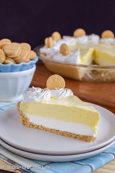 a slice of cheesecake on a white plate with crackers in the bowl behind it