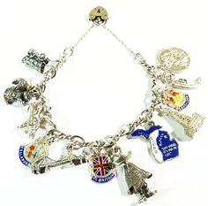 "A unique gift for her - a one of a kind travel / holiday themed charm bracelet. This is a delightful 1960s hallmarked infinity chain (also known as a figure of eight chain) charm bracelet with the traditional padlock heart clasp.  The charms are high quality vintage sterling silver and much more detailed than modern charms. The aspect that makes this bracelet so collectible is that the charms originate from the countries they represent - all the British ones - St.Christopher, Blackpool Tower, Union Flag, Basildon & Callander shields were made in Great Britain. The gondolier & gondola are made from 800 silver which was made in Italy. Then we have an enamel Alpena, Michigan charm signed \" KINNEY STERLING \", the Golden Gate Bridge, a Sterling Bell Jacob Lake squirrel and a covered wagon wh Antique Charm Bracelet Gift, Vintage Charm Bracelet As A Gift, Vintage Charm Bracelet As Gift, Antique Charm Bracelet As Gift, Symbolic Vintage Charm Bracelet For Gift, Vintage Bracelet Charms For Gift, Retro Jubilee Bracelet Jewelry As Gift, Vintage Charm Bracelet For Gifting, Handmade Vintage Charm Bracelet Gift