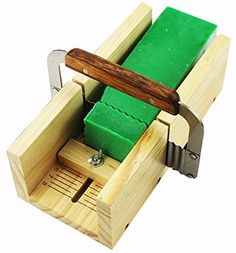 a small wooden tool holder with green paper in it