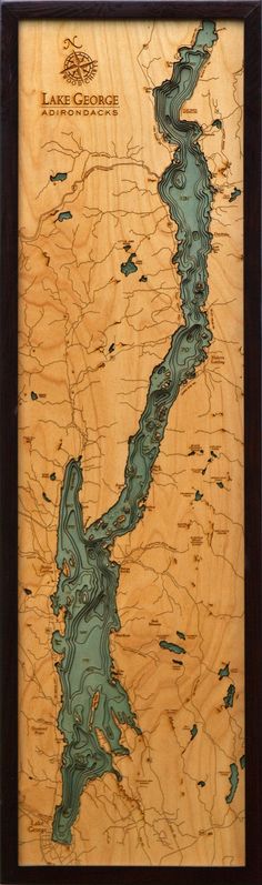 a wooden plaque with an image of a lake and mountains on it's side