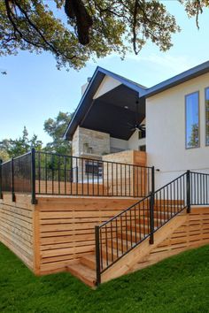 a house with wooden steps and railings in the grass