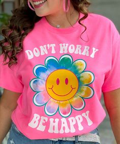 Introducing our Don't Worry Be Happy Flower Smiley Graphic Shirt, a vibrant and uplifting addition to your wardrobe that spreads positivity and joy wherever you go. This captivating shirt features a colorful design on a neon pink background, guaranteed to make a bold statement. The focal point of the design is a cheerful daisy with a smiley face center, radiating happiness and warmth. Encircling the flower are the words "Don't worry be happy," serving as a gentle reminder to embrace a positive m Neon Pink Background, Neon Pink Shirts, Mothers Day Crafts Preschool, Smiley Graphic, Cheerful Daisy, Flower Smiley, Bride Workout, Don't Worry Be Happy, Happy Flowers