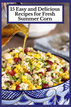 a bowl filled with corn and dressing being poured over it to make a colorful salad