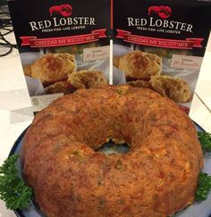 two packages of red lobster bread on a blue plate with parsley sprigs