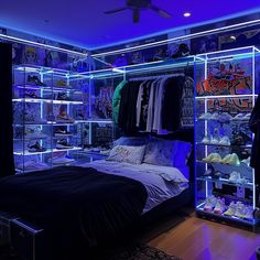 a bedroom with blue lighting and lots of shoes on the shelves in front of the bed