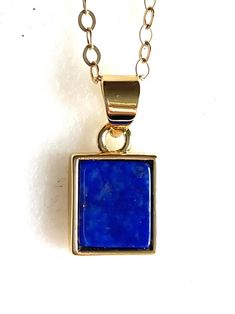 Rich blue lapis lazuli gemstone set in 24k gold fill bezel and nail on delicate 14k gold fill necklace.  Beautiful trendy rectangular lapis lazuli pendant is 17.7 x 9.7mm in rich blue color with tiny flecks of golden pyrite. Completely natural gemstone.  Lapis lazuli pendant hangs from delicate 14k gold fill flat cable chain with spring ring clasp. Yellow Gold Lapis Lazuli Minimalist Jewelry, Minimalist Yellow Gold Lapis Lazuli Jewelry, Gold Necklaces With Rectangular Natural Stones, Gold Rectangular Necklaces With Natural Stones, Gold Necklace With Rectangular Natural Stones, Adjustable Gold Jewelry With Rectangular Stone, Blue Rectangular Spiritual Jewelry, Spiritual Blue Rectangular Jewelry, Blue Lapis Lazuli Rectangular Jewelry