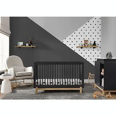 a baby's room with grey walls and white furniture, including a crib