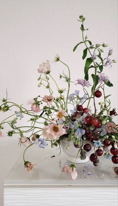 a vase filled with lots of different types of flowers