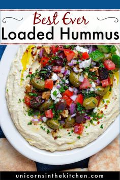 the best ever loaded hummus recipe on a plate with crackers