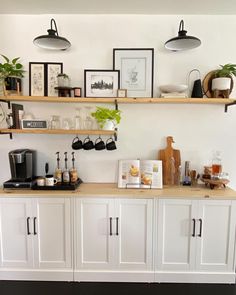 there is a coffee bar with white cabinets