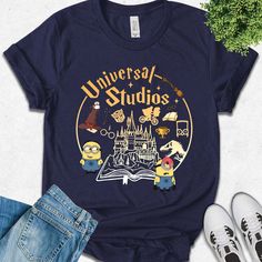 a t - shirt with the words universal studios on it next to jeans and sneakers