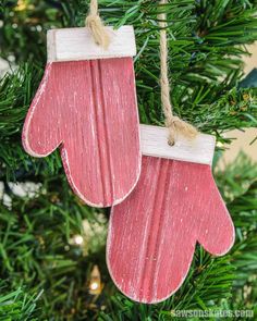 two wooden mittens hanging from a christmas tree with text overlay that says free - plans diy mitten ornaments