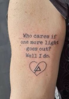 a man with a tattoo on his arm that says who cares if one more light goes out? well i do