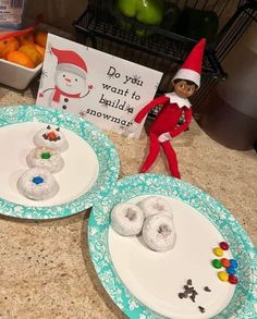 two plates with doughnuts on them and an elf standing next to the plate