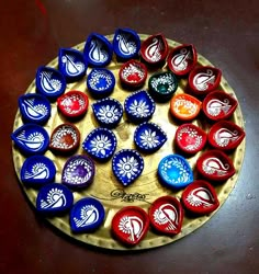 a wooden plate topped with lots of red, white and blue bottle cap magnets