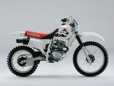 a white and red dirt bike on a gray background