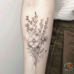 a woman's arm with flowers on it