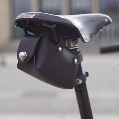 a close up of a bike handlebar with a bag on it