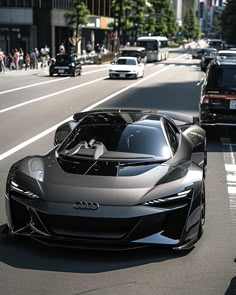 an audi sports car driving down the street