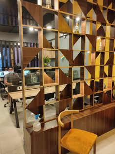 an office cubicle with wooden shelves and chairs